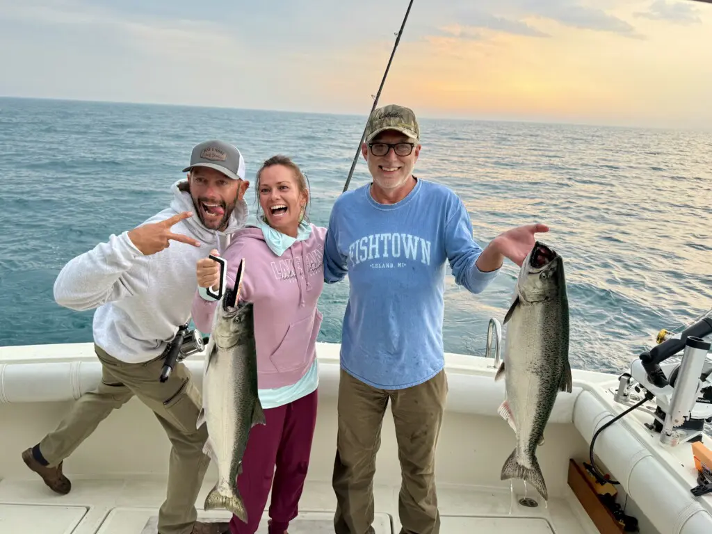 Salmon fishing Lake Michigan with Just One More Charters at sunset