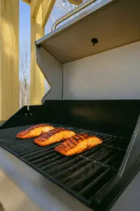 Grilled teriyaki salmon cooking on a Nexgrill under the pergola at Copper Top Ridge