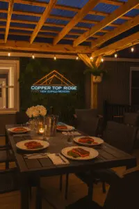 Grilled teriyaki salmon served at a twilight dinner table under pergola lights at Copper Top Ridge