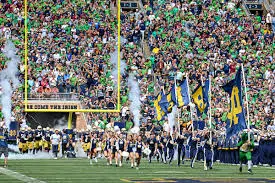 Fans tailgating outside Notre Dame Stadium on a sunny game day in South Bend
