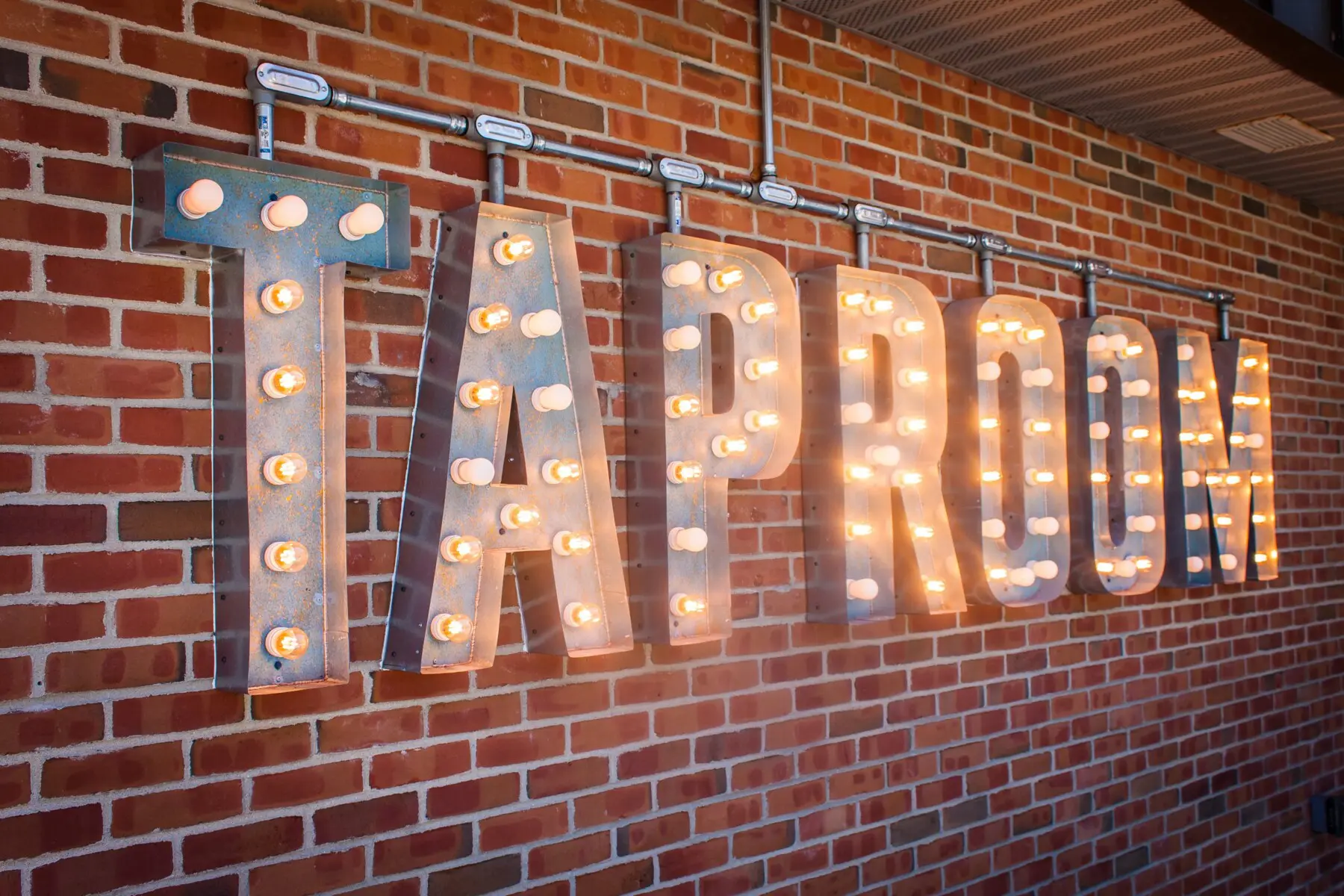 Haymarket Taproom | Things to Do in Southwest Michigan: Outdoor seating and brewery with guests enjoying beer in the sunshine