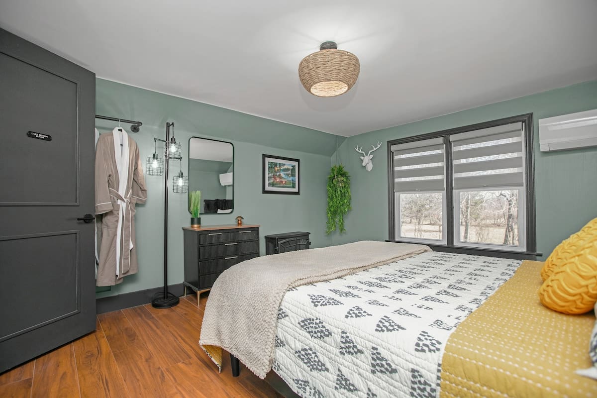 Lake Huron Room at Copper Top Ridge featuring green walls, antler wall mount, and a comfy accent chair