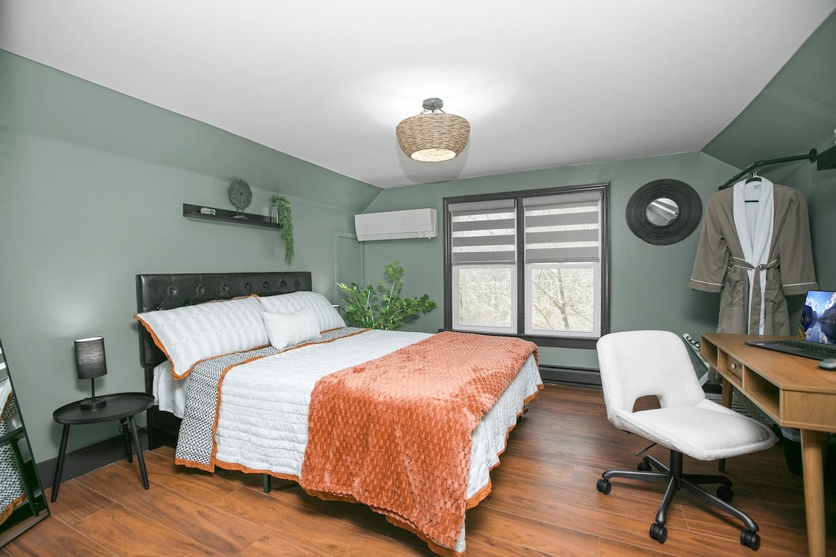 Work nook in the Lake Michigan Room with a wooden desk, chair, and a view toward the window