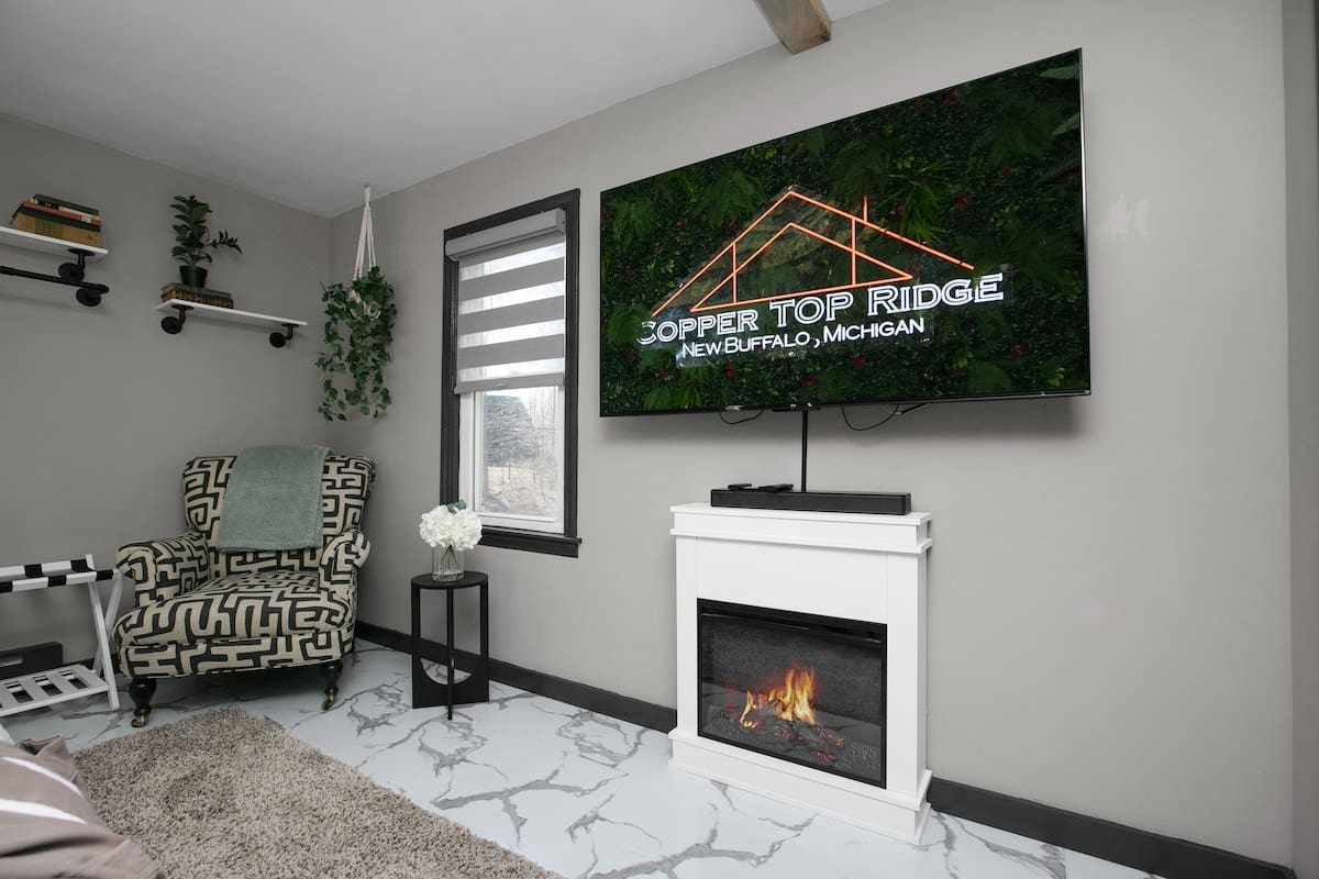 Reading nook with modern armchair and greenery in Lake Erie Room