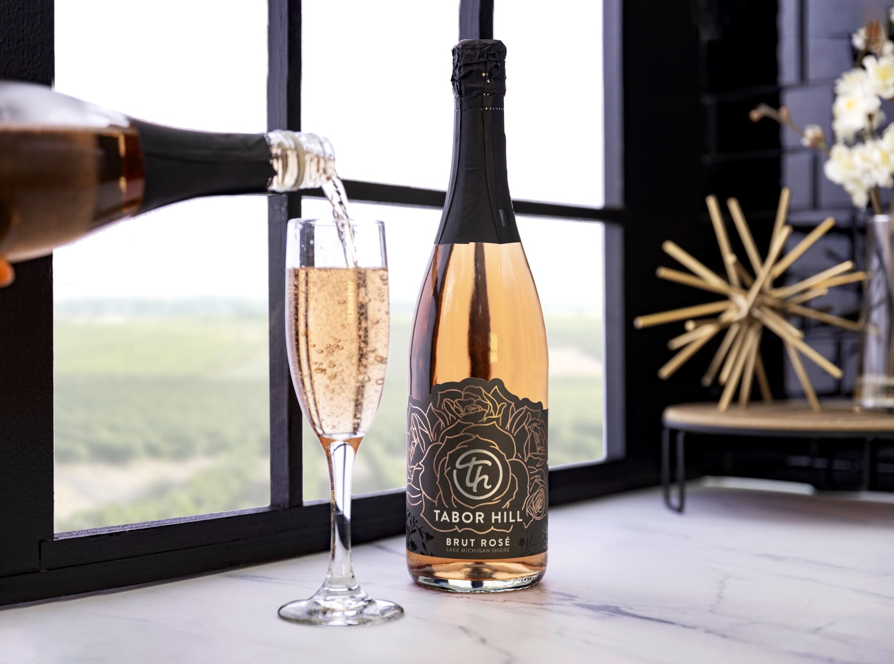 Tabor Hill Winery & Restaurant | Things to Do in Southwest Michigan: Guests enjoying wine and food on a vineyard-view patio at a scenic Michigan winery.