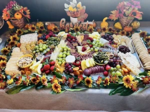 Artisan charcuterie board featuring meats, cheeses, fruit, and nuts from Feeling Grazey