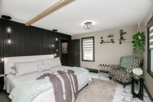 Luxury Vacation Rental in New Buffalo – Modern Bedroom Design Luxury Vacation Rental in New Buffalo featuring a modern cottage-style bedroom with king bed, designer chair, and elegant decor.