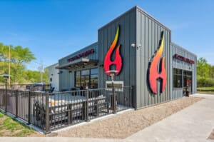 Modern exterior of Rolling Embers in New Buffalo with its flame logo and patio lounge, located right beside Four Winds Casino